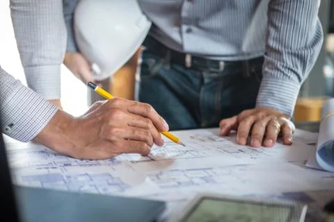 Construction engineering or architect discussing a blueprint and building mod Stock Photos