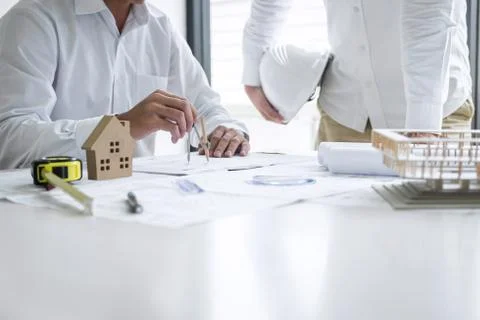 Construction engineering or architect discussing a blueprint and building mod Stock Photos