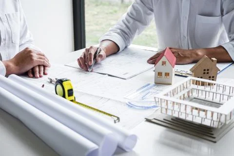 Construction engineering or architect discussing a blueprint and building mod Stock Photos