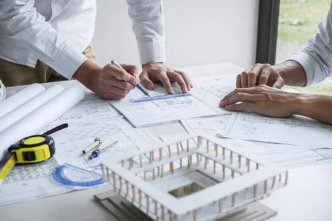 Construction engineering or architect discussing a blueprint and building mod Stock Photos