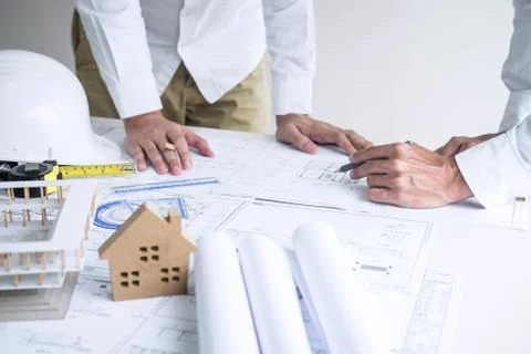 Construction engineering or architect discussing a blueprint and building mod Stock Photos