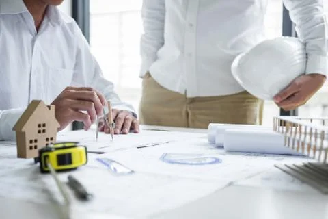 Construction engineering or architect discussing a blueprint and building mod Stock Photos