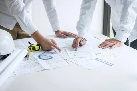 Construction engineering or architect discussing a blueprint and building mod Stock Photos