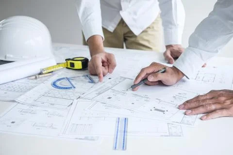 Construction engineering or architect discussing a blueprint and building mod Stock Photos