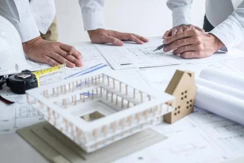 Construction engineering or architect discussing a blueprint and building mod Stock Photos
