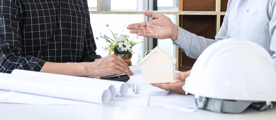 Construction engineering or architect discussing a blueprint and building mod Stock Photos
