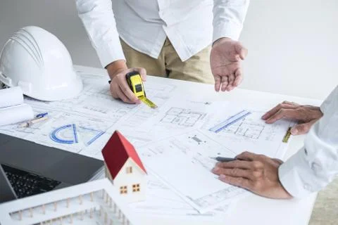 Construction engineering or architect discussing a blueprint and building mod Stock Photos