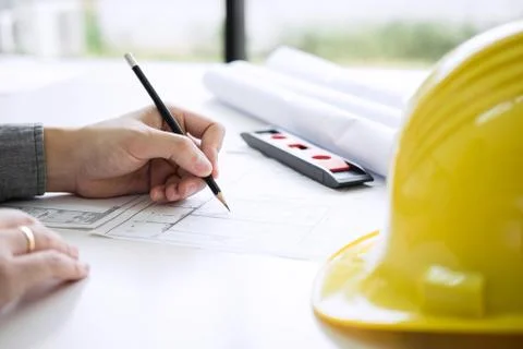 Construction engineering or architect hands working on blueprint inspection i Stock Photos