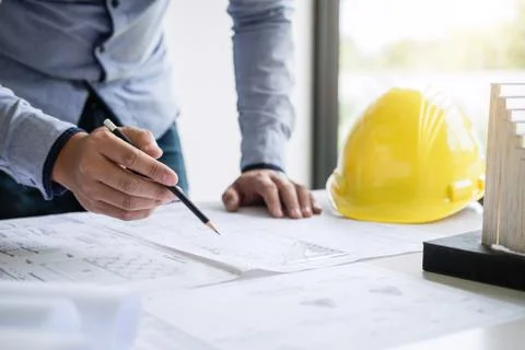 Construction engineering or architect hands working on blueprint inspection i Stock Photos
