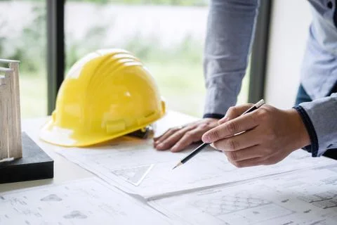 Construction engineering or architect hands working on blueprint inspection i Stock Photos