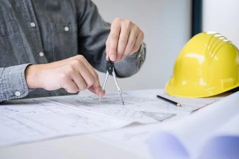 Construction engineering or architect hands working on blueprint inspection i Stock Photos