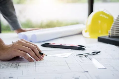 Construction engineering or architect hands working on blueprint inspection i Stock Photos