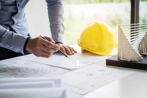 Construction engineering or architect hands working on blueprint inspection i Stock Photos