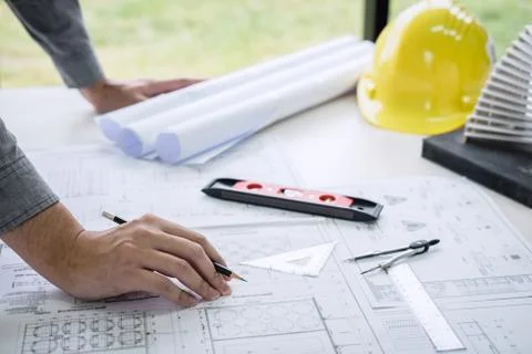 Construction engineering or architect hands working on blueprint inspection i Stock Photos
