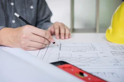 Construction engineering or architect hands working on blueprint inspection i Stock Photos