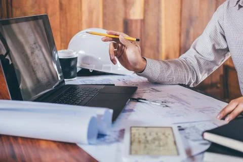 Construction engineering or architect hands working on blueprint inspection i Stock Photos