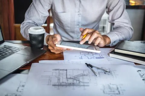 Construction engineering or architect hands working on blueprint inspection i Stock Photos