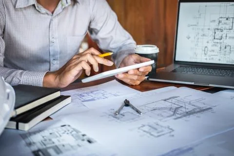 Construction engineering or architect hands working on blueprint inspection i Stock Photos