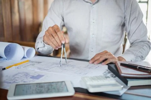 Construction engineering or architect hands working on blueprint inspection i Stock Photos