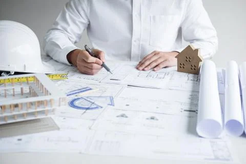Construction engineering or architect hands working on blueprint inspection i Stock Photos
