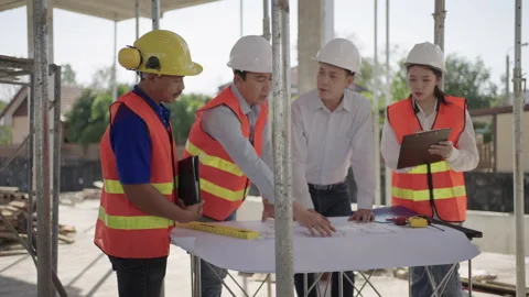Construction engineering team meeting with house plans in a house. Stock Footage 171614032