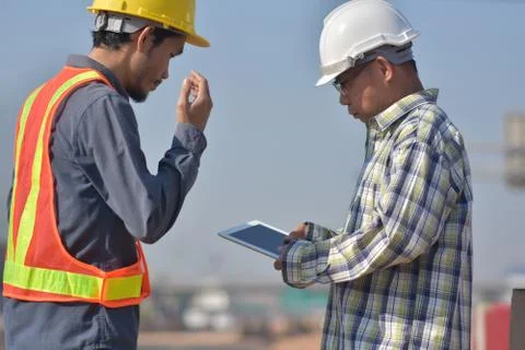 Construction Engineering use white tablet application working building estate Stock Photos