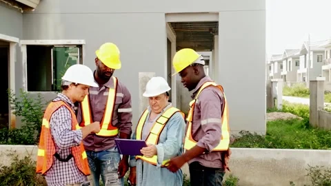 Construction engineers and workers gather at a housing development site. Stock-Footage 312617436