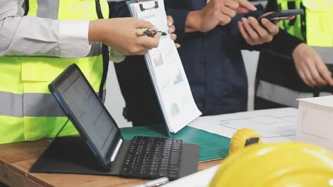 Construction engineers discussing project in office Stock Footage 331671377