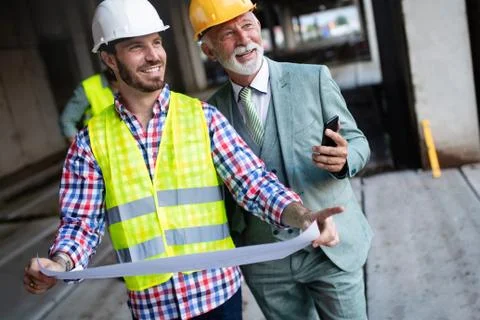 Construction engineers discussion with architects at construction or building Fotos de archivo