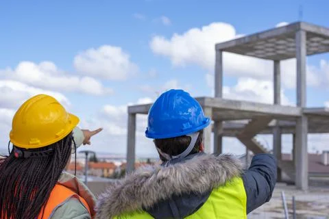Construction engineers discussion with architects at construction site or bui Stock Photos