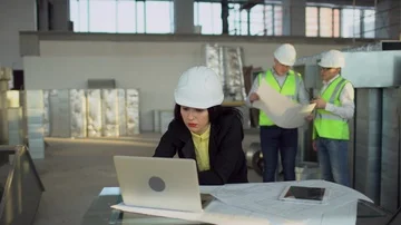 Construction engineers female or architects wearing had hats use the laptop Stock Footage 85826973