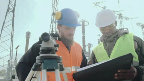 Construction engineers with folder discuss station project Stock Footage 142898385
