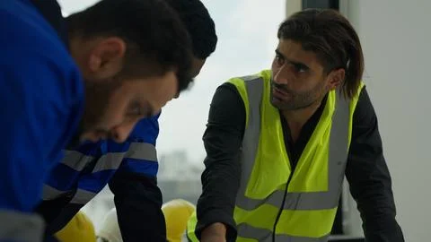 Construction engineers team using blueprint of project plan brainstorming Stock Photos