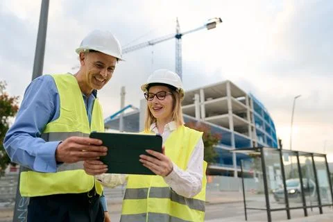 Construction engineers working together using digital tablet Stock Photos