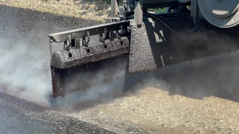 Construction equipment applies bituminous emulsion to the road Stock-Footage 247268386