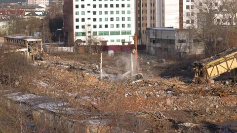 Construction Equipment Is Engaged In The Demolition Of The Walls Of Old Factory Stock Footage 84316358