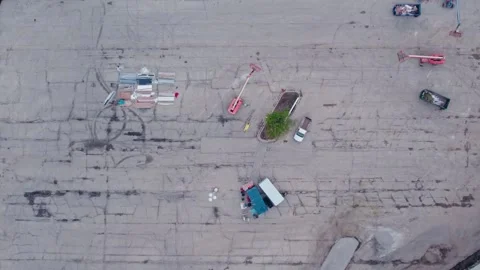 Construction equipment on a huge parking lot. Top down aerial Stock Footage 252059997