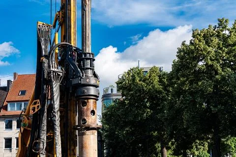 Construction equipment operates under a clear sky Stock Photos