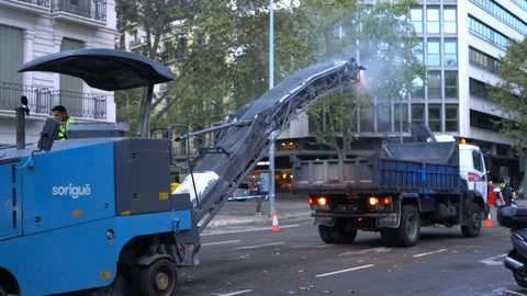 Construction equipment removes layer of asphalt from road and loads into truck Stock-Footage 118320515