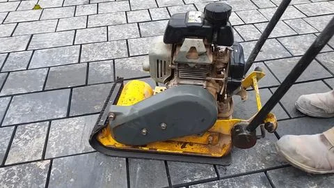 Construction equipment used for compacting pavement on a construction site Stock Photos