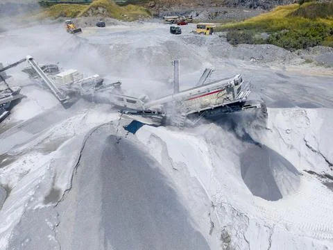 Construction equipment works on a mining site in a sunny location Stock Photos