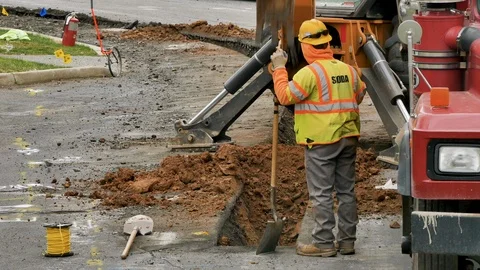 Construction excavator digging trench wide shot Stock Footage 106365095