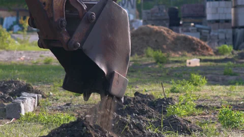 Construction excavator unloading soil Stock Footage 132033854