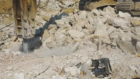 Construction excavator working with industrial jackhammer splits blocks of Stock Footage 314060385