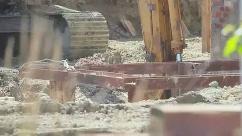 Construction extravator digging in the ground Stock Footage 98247802