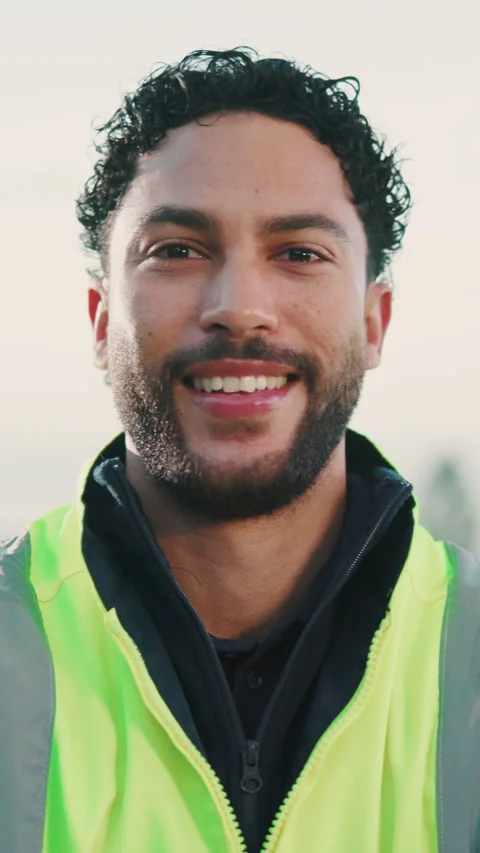 Construction, face and happy man outdoor with pride, contractor and ambition in Stock Footage 346940169