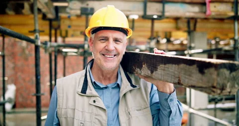 Construction, face or man on site with plank, positive attitude or pride as Stock Footage 337016077