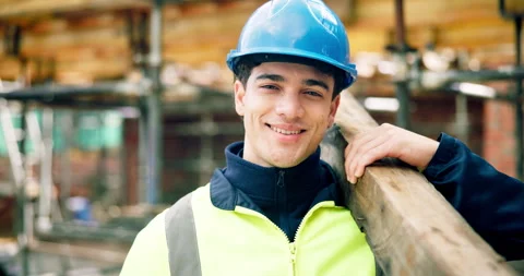 Construction, face or man on worksite with wooden plank, positive attitude or Stock Footage 337016014