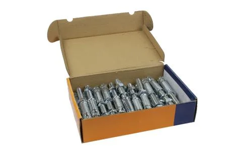 Construction fastening, wedge galvanized anchor in a cardboard carob, isolate Stock Photos