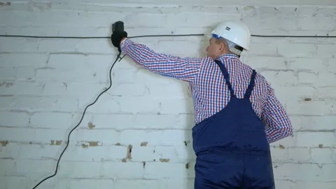 Construction of a fiber optic communication line along the wall. Stock Footage 150599794